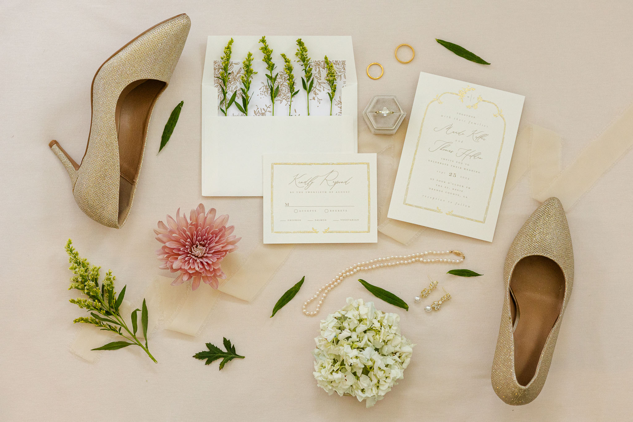 wedding flat lay of invitation suite and brides shoes